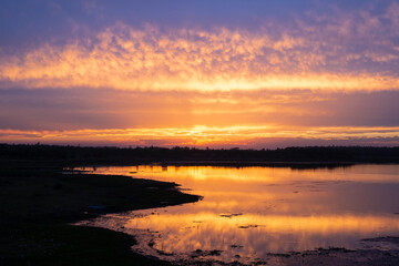Obraz premium Sunset over water body