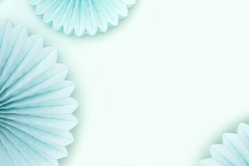 Frame made of tissue paper fans on a blue background. Festive creative concept.