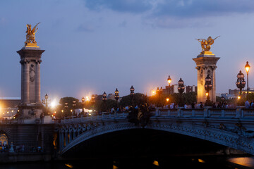 Naklejka premium Pont Alexandre III Bridge and illuminated lamp posts at sunset. 7th Arrondissement, Paris, France
