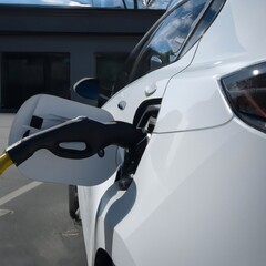 Close-up of A Electric Car getting electricity from EV Charging Station. Generative Ai