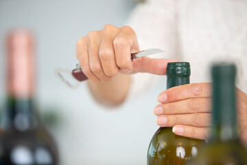 sommelier open wine bottle with corkscrew