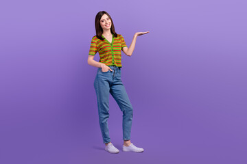 Full length photo of cute adorable lady wear striped cardigan holding arm empty space isolated purple color background