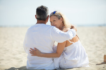 happy romantic middleaged couple in love hugging on the beach