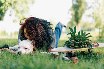 beautiful white dog of pitbull breed staffordshire terrier on a walk in the park with the owner on...