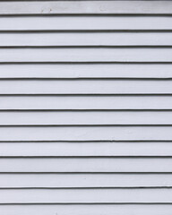 White-painted wooden board wall with overlapping planks.