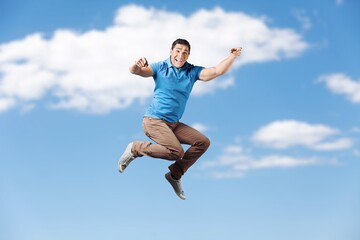 Young fun person jump on sky background