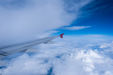 Fototapeta premium View of the aircraft wing and Earth from the airplane porthole. Travel concept.