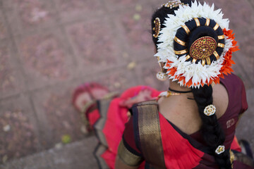 Beautiful Indian classical Bharatanatyam dancer wearing red saree and performing in various locations.
