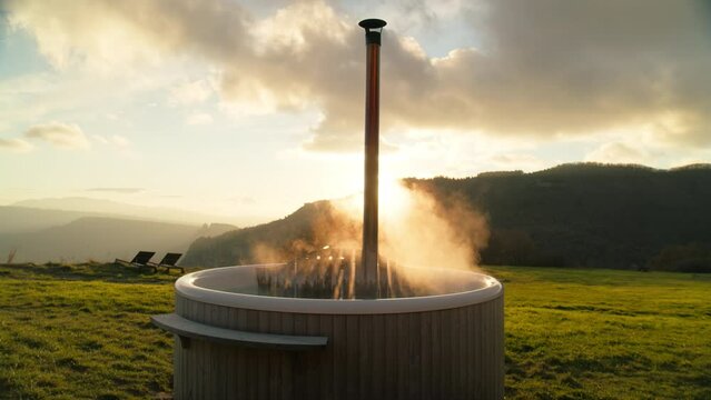 Hot steaming outdoor jacuzzi or wood heated hot tub. Holistic and relaxing experience in glamping spa or hotel. Connecting to nature. All natural therapeutical wellness spot