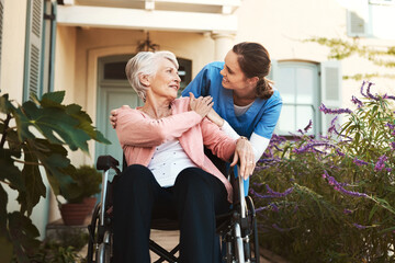 Senior woman, wheelchair and nurse in healthcare support, talking or garden walk at nursing home. Happy elderly female and caregiver helping patient or person with a disability, health or retirement - obrazy, fototapety, plakaty