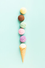Flying ice cream balls on pastel light blue background