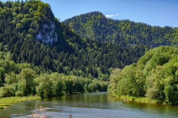 Rafting on Dunajec river in Szczawnica on a sunny spring day in Pieniny National Park in Poland.