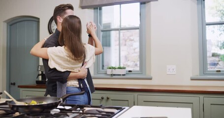 Cooking, love and couple dance in kitchen for lunch, supper and romantic dinner together. Marriage, love and happy man and woman at home with food for meal prep dancing for bonding, fun and happiness
