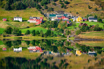 Fototapeta na wymiar Beautiful Norwegian Houses reflection in Granvinsvatnet lake Norway, Scandinavia, Europe