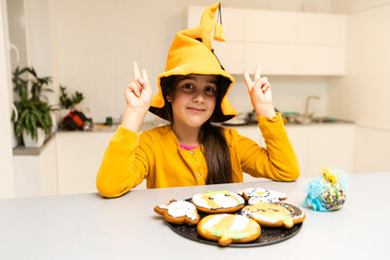Fototapeta Happy Halloween. Cute little witch with cookies pumpkins obraz