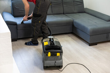 Fototapeta Hand cleaning a sofa with a steam cleaner, Home cleaning concept obraz