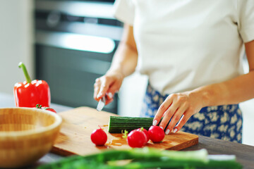 Female hands cooking healthy dinner at kitchen