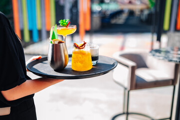 glasses alcohol cocktail set on a waiter tray in bar
