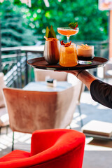 glasses alcohol cocktail set on a waiter tray in bar