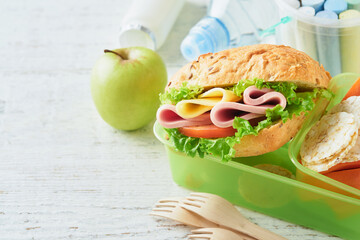 Healthy food for school lunch concept. Healthy bread, meat sandwich with cheese, apple, fresh...