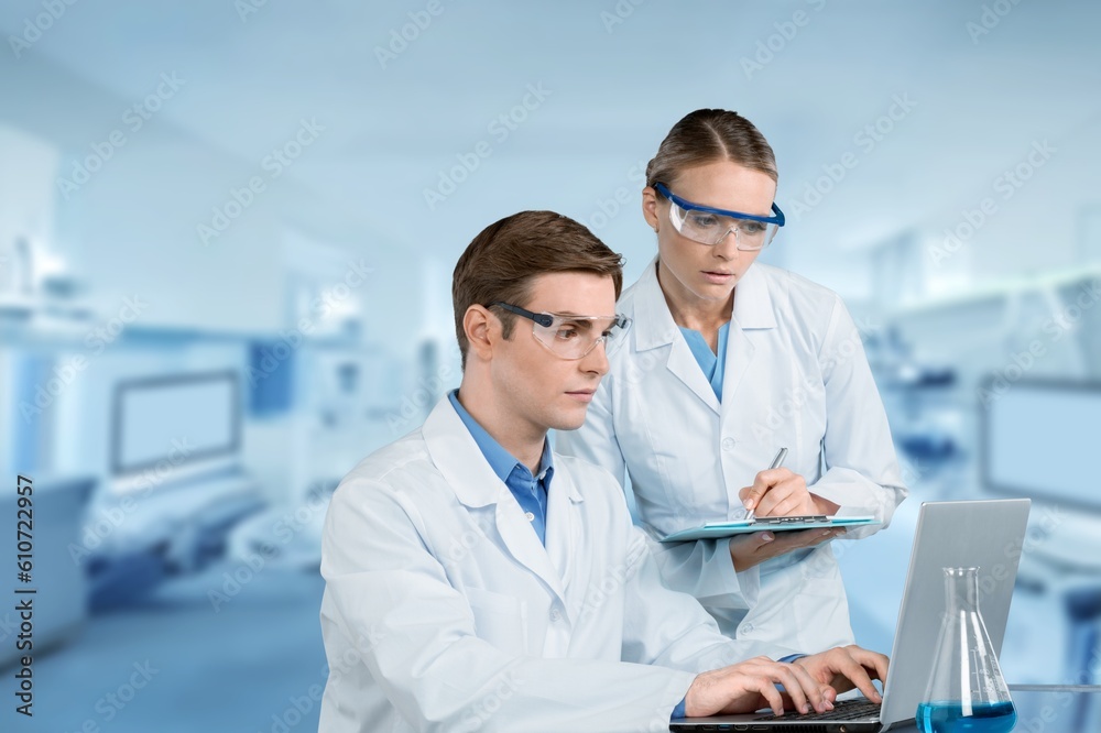 Wall mural Two smart scientists using computer in medical laboratory