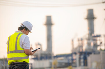 Asian man petrochemical engineer working at oil and gas refinery plant industry factory,The people worker man engineer work control at power plant energy industry manufacturing