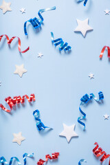 USA Independence day concept. Red and blue spirals and white stars elements of USA flag top view, flat lay on blue background