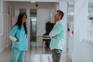A doctor in a discussion with a nurse about medical problems and patient care in a modern hospital, highlighting their collaborative approach, expertise, and dedication to finding effective solutions
