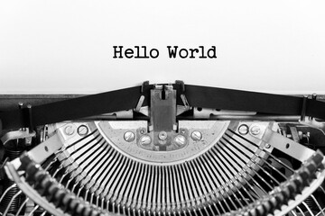 Hello World phrase closeup being typing and centered on a sheet of paper on old vintage typewriter mechanical