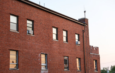 Fototapeta premium Old brick buildings symbolize timeless elegance, heritage, stability, and a sense of history in the business office environment