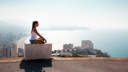 Summer vacation travel Spain photo - girl on the top of the mountain near Benidorm watching on the beach