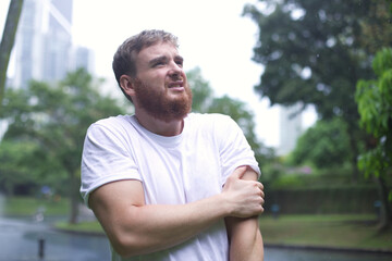 Sad frozen man under summer rain.emotional wet in the rain without umbrella walk in the rain.young...