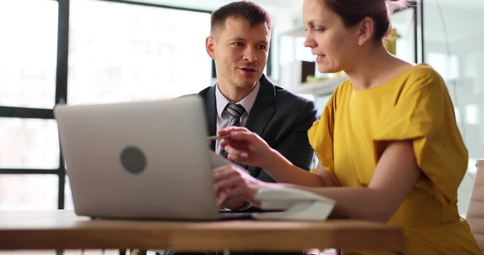 Colleagues are discussing working together on online project, using laptop. Teamwork cooperation, help and coaching concept