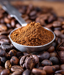 Roasted coffee beans in a metal spoon