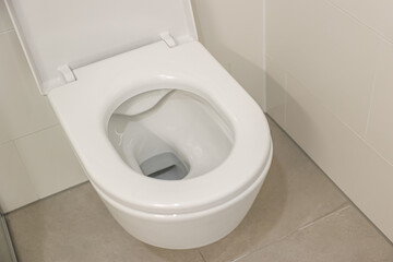 White toilet bowl in room, closeup