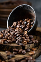 Coffee beans placed on rustic wood and overturned metal bowl