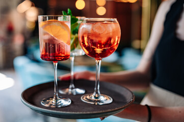 glasses alcohol cocktail set on a waiter tray in bar