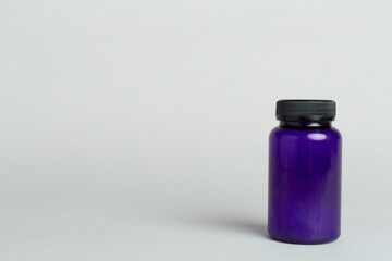 Plastic bottle for vitamins on color background