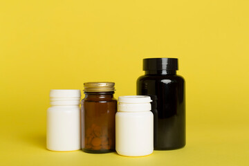 Plastic bottles for vitamins on color background