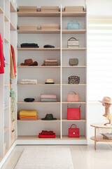Shelves with stylish clothes and accessories in boutique
