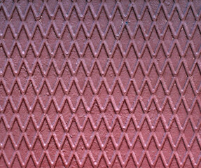 The image of a pattern on a metal surface in the form of a zigzag across the entire field of the frame.