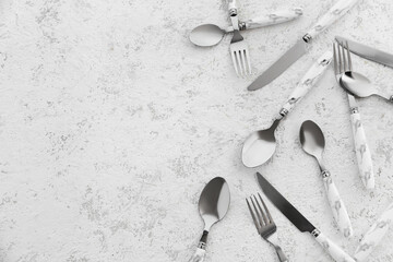 Stainless steel cutlery with plastic handles on white background