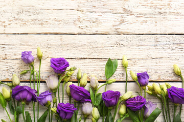 Beautiful eustoma flowers on light wooden background