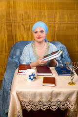 A Jewish woman in a kisui rosh headdress, a teacher of tradition, lectures for women and tells...
