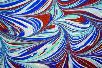 Ebru art. Traditional Turkish Ebru technique. Painting on water, followed by paper prints. Color paint ebru with waves and tile pattern.