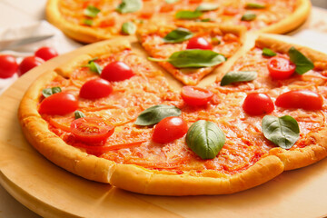 Board with tasty pizza margarita, closeup