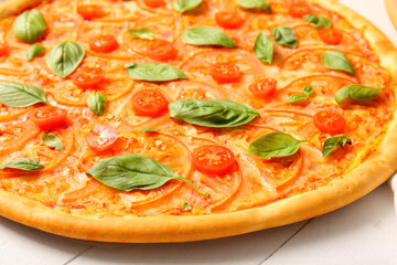 Tasty pizza margarita on white wooden background
