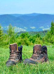 Hiking boots on a trail in the mountains.
Small depth of field. Selective focus, fall background.