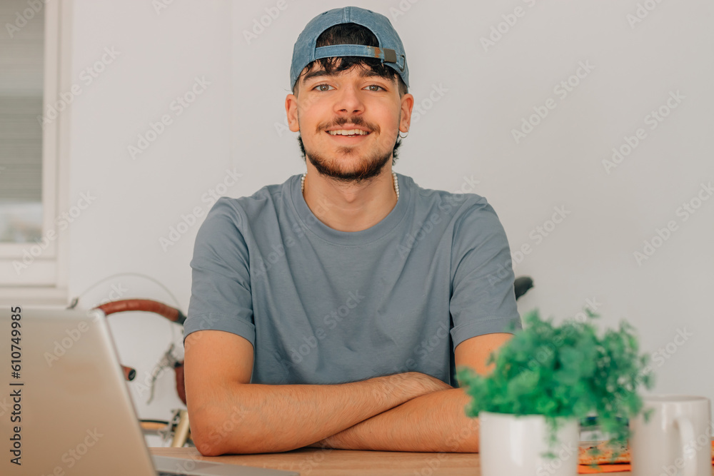 Wall mural young man or student at desk with computer or laptop