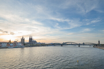 Fototapeta premium Panoramic view of the Rhine river at sunset as it passes through the city of Cologne in Germany.
